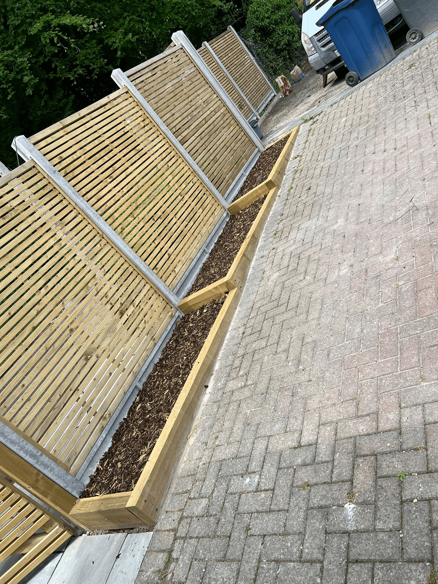 Fencing with raised planters on driveway